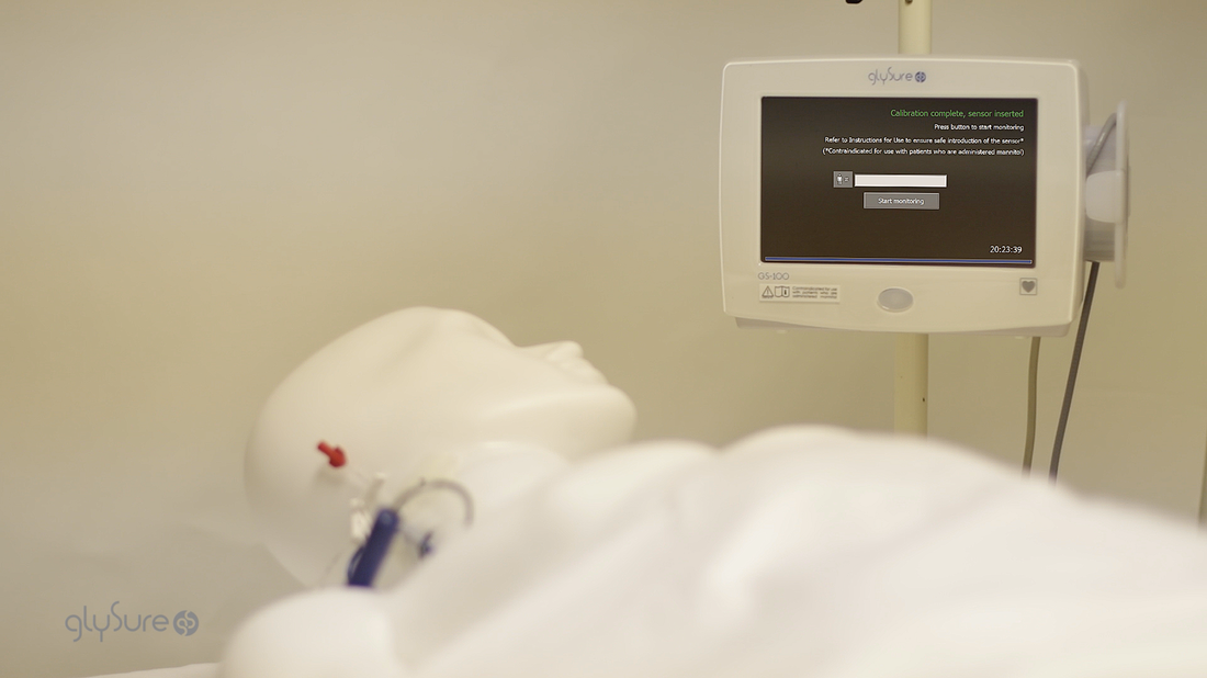 animated video still of a dummy on a hospital bed with a monitoring system